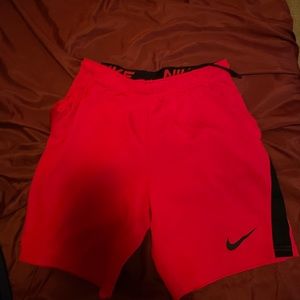red athletic nike shorts slightly worn